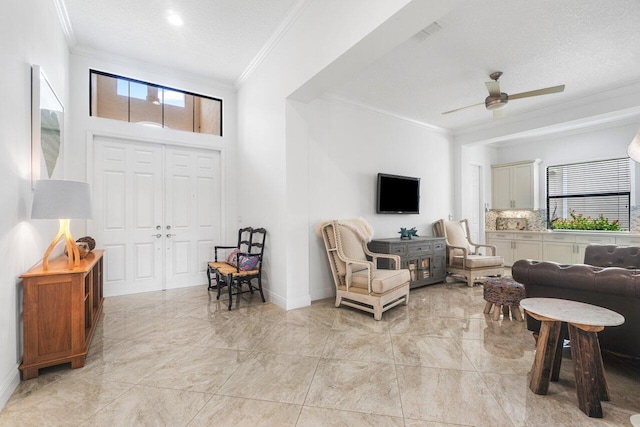 living room featuring a textured ceiling, crown molding, and ceiling fan