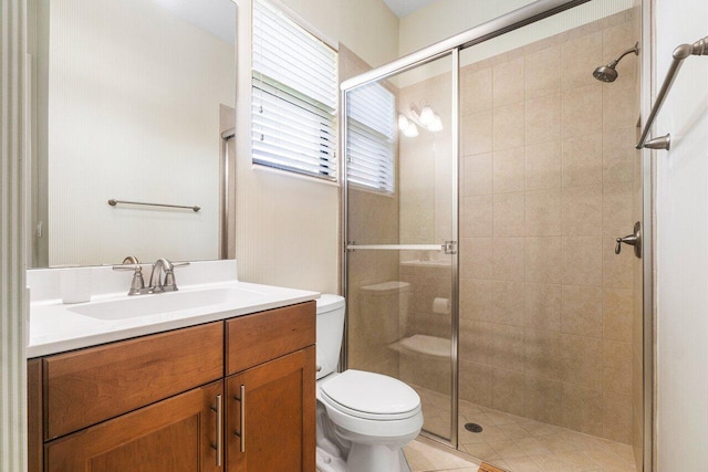 bathroom with walk in shower, vanity, and toilet