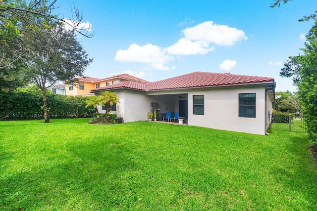 back of property featuring a patio and a yard