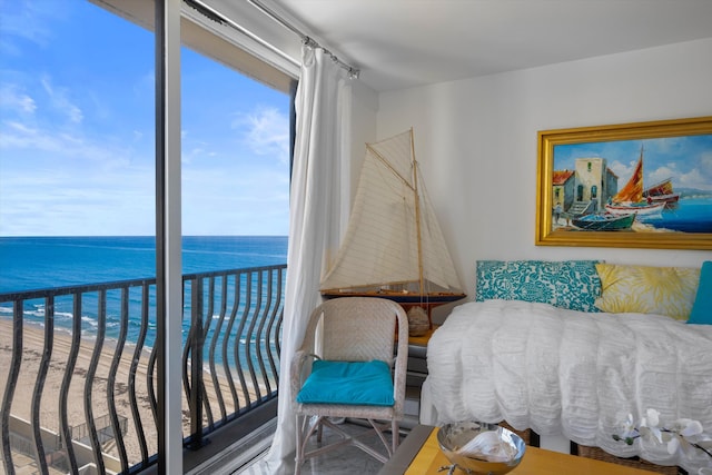 bedroom with a view of the beach, wood-type flooring, and a water view