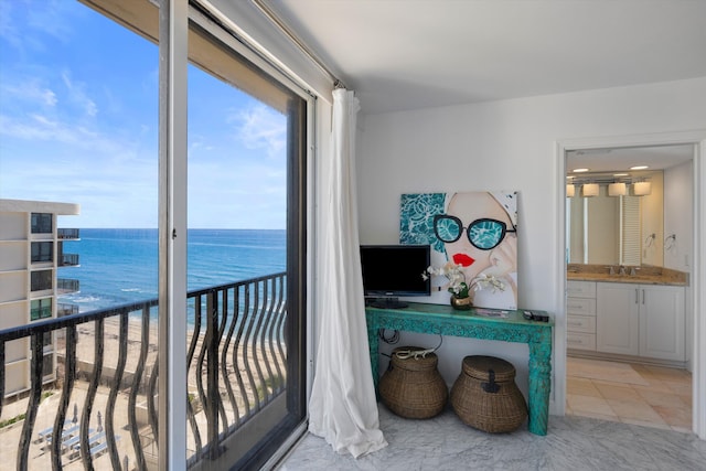 interior space featuring a water view and sink