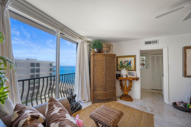 living room featuring a water view and ceiling fan