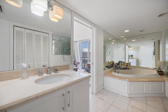 bathroom featuring vanity, a bathtub, and tile patterned flooring