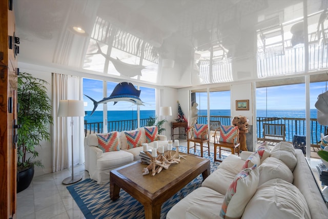 tiled living room featuring a water view