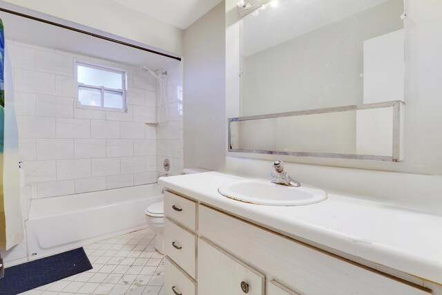 full bathroom featuring vanity, toilet, and tiled shower / bath combo