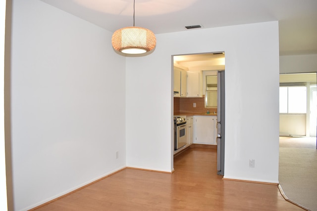 empty room with light hardwood / wood-style flooring