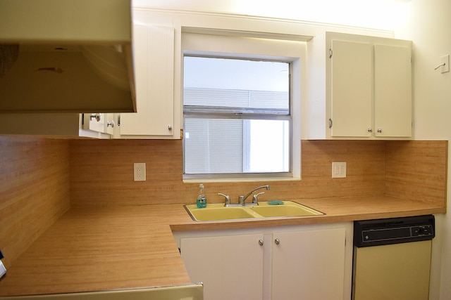 kitchen with white cabinetry, sink, dishwasher, and tasteful backsplash