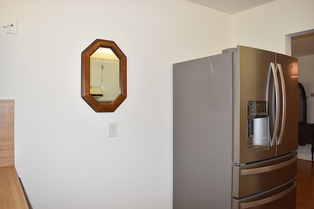 kitchen with stainless steel refrigerator with ice dispenser and hardwood / wood-style flooring