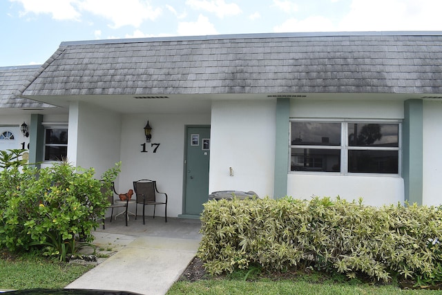 view of exterior entry featuring covered porch