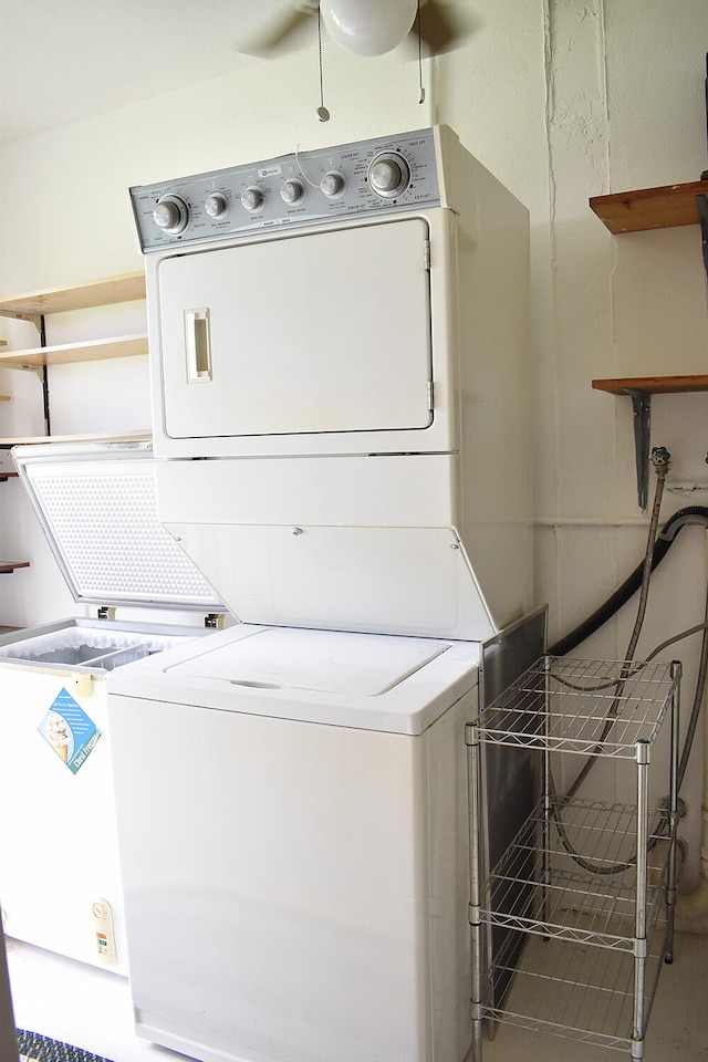 washroom featuring stacked washer and clothes dryer and ceiling fan