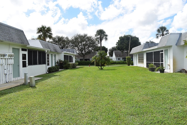 view of yard featuring a sunroom