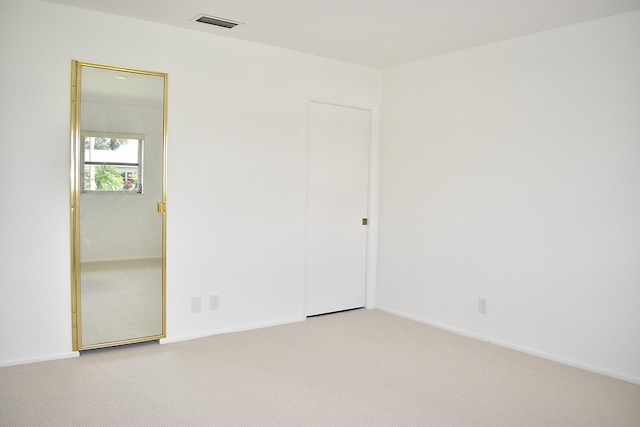 spare room with light colored carpet