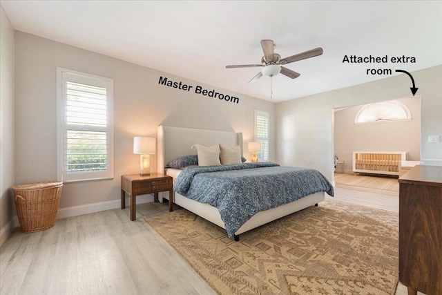 bedroom featuring hardwood / wood-style floors, radiator heating unit, and ceiling fan