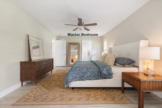 bedroom featuring connected bathroom, light hardwood / wood-style floors, and ceiling fan