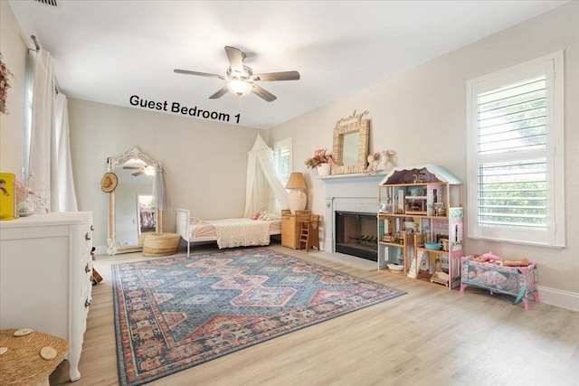 living area with hardwood / wood-style flooring and ceiling fan