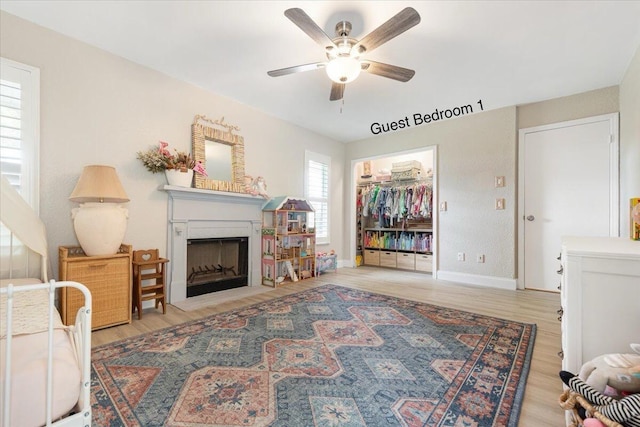 living room featuring ceiling fan and light hardwood / wood-style floors