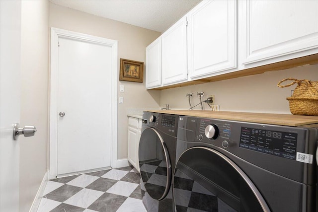 laundry room with cabinets and washing machine and clothes dryer