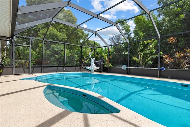 view of pool featuring glass enclosure