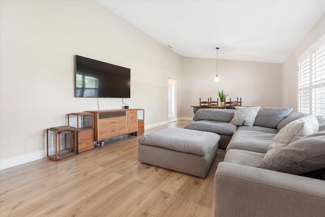 living room with lofted ceiling and light wood-type flooring