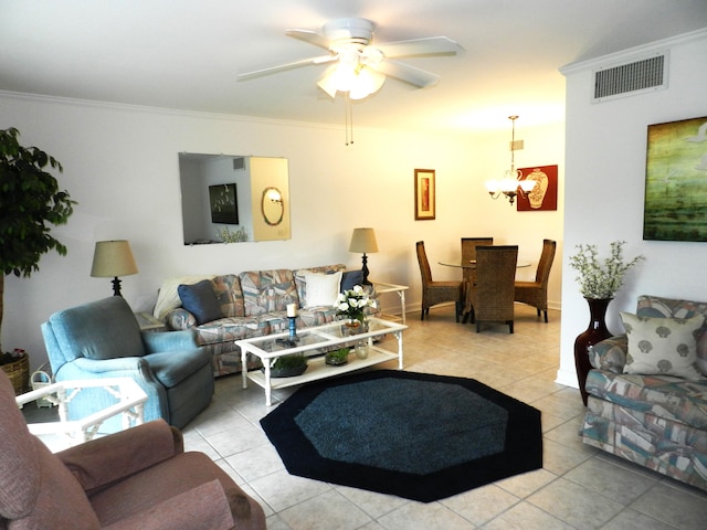 living room featuring light tile patterned floors, ceiling fan with notable chandelier, and ornamental molding