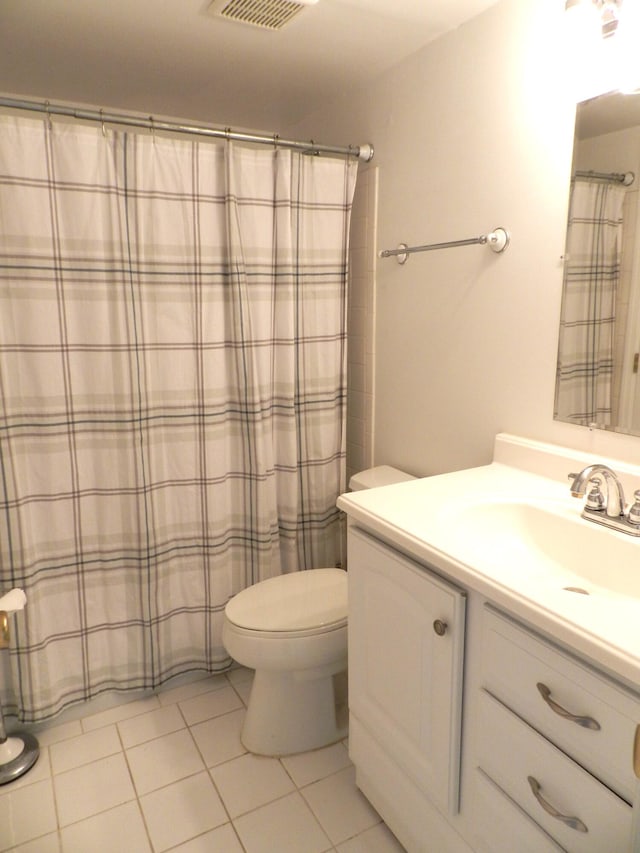 bathroom with tile patterned flooring, vanity, toilet, and a shower with curtain