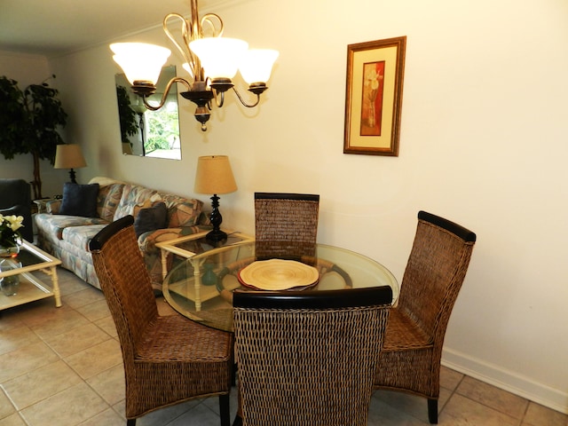 tiled dining room with a notable chandelier