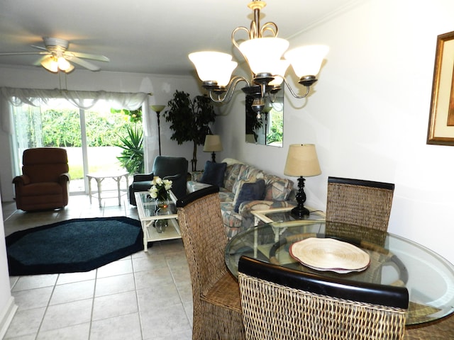 tiled dining area featuring ceiling fan with notable chandelier and crown molding