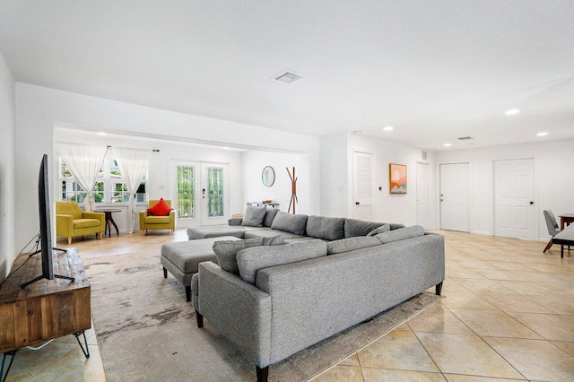 tiled living room featuring french doors