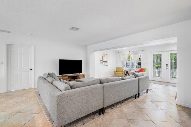 tiled living room featuring french doors