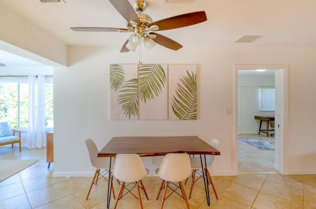 dining space with ceiling fan and light tile patterned floors