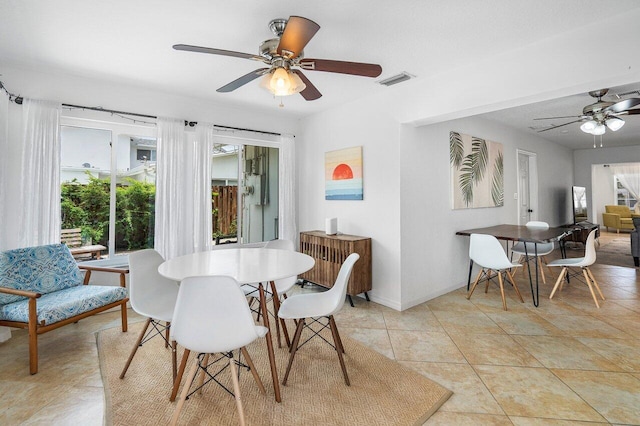 tiled dining space with ceiling fan