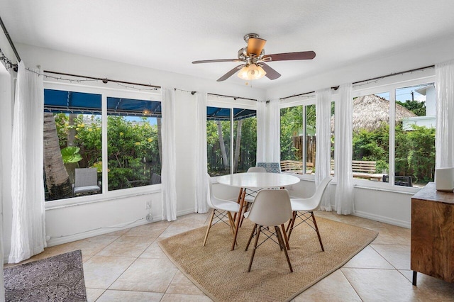 sunroom / solarium featuring ceiling fan