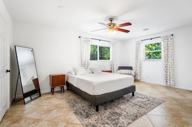 bedroom with ceiling fan and light tile patterned floors