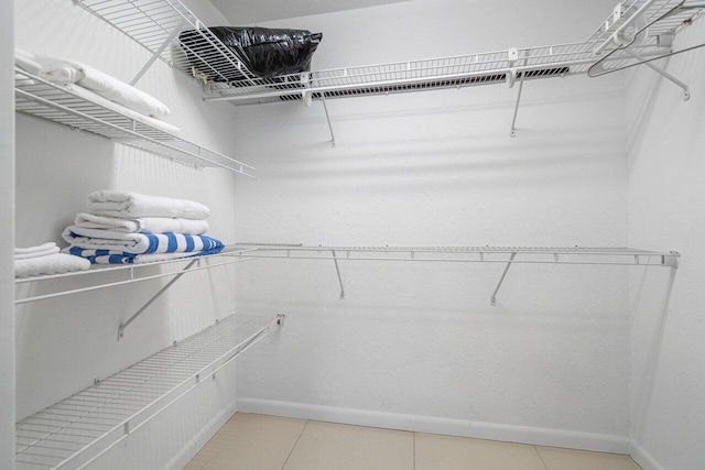 spacious closet with tile patterned floors