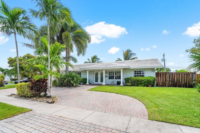 view of front of home with french doors and a front lawn