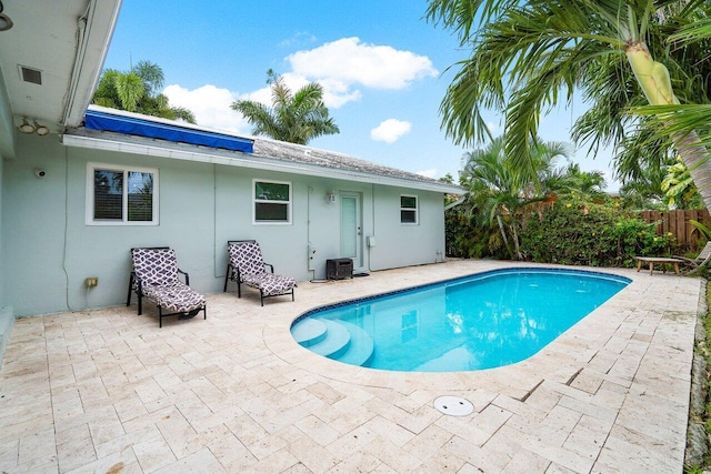 view of pool with a patio and central AC