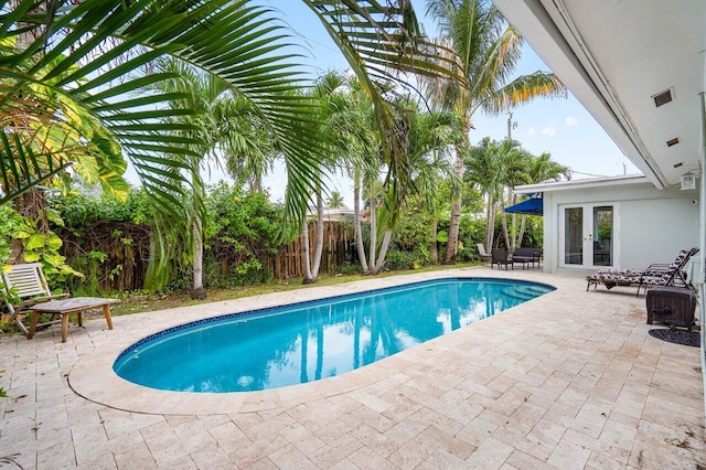 view of pool featuring french doors and a patio area