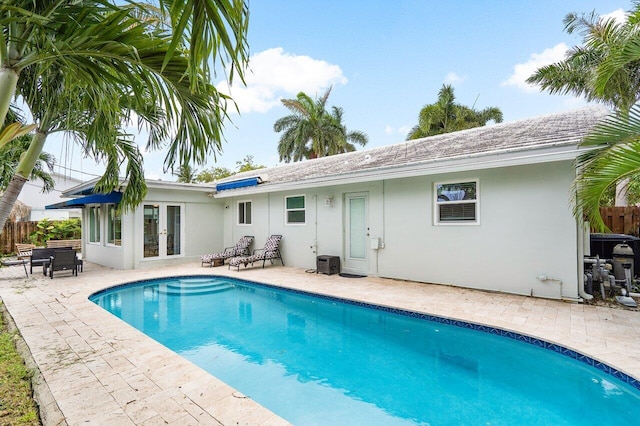 view of pool featuring a patio and central AC unit