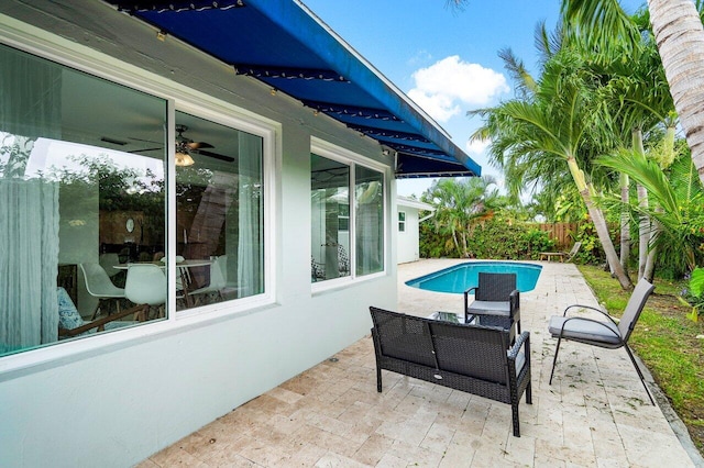 view of patio featuring a fenced in pool and ceiling fan