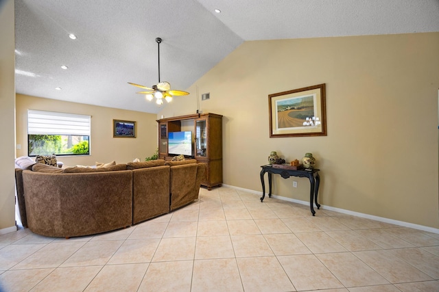 tiled living room featuring lofted ceiling, ceiling fan, and a textured ceiling