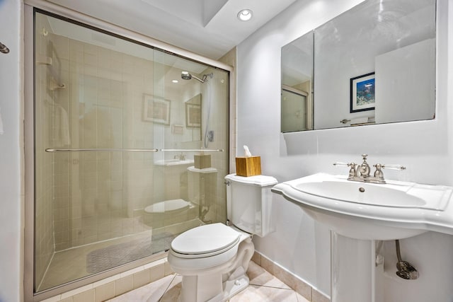 bathroom with walk in shower, toilet, and tile patterned floors