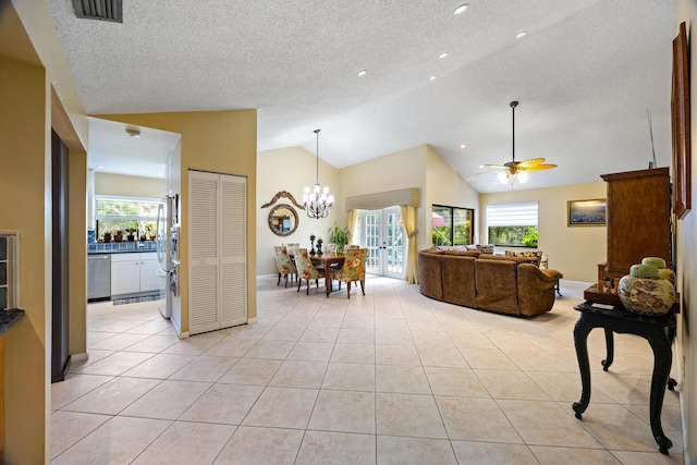 tiled living room featuring a textured ceiling, ceiling fan with notable chandelier, and high vaulted ceiling