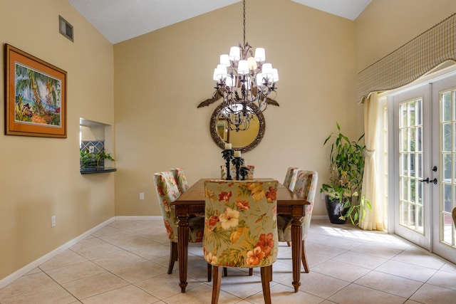 tiled dining area with a healthy amount of sunlight, high vaulted ceiling, french doors, and a notable chandelier