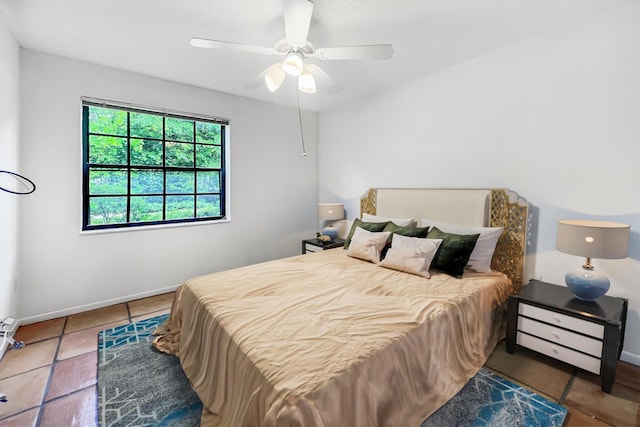 bedroom with tile patterned floors and ceiling fan