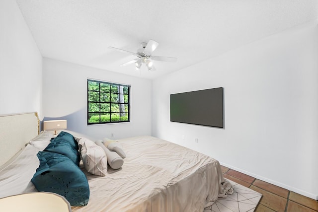 tiled bedroom featuring ceiling fan