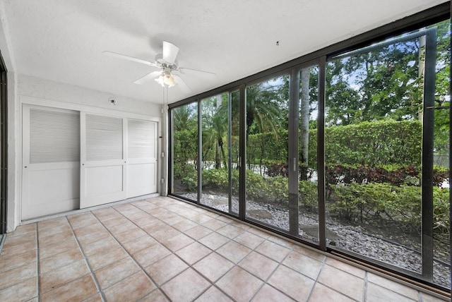 unfurnished sunroom with ceiling fan and a healthy amount of sunlight