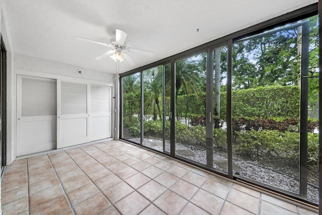 unfurnished sunroom featuring ceiling fan