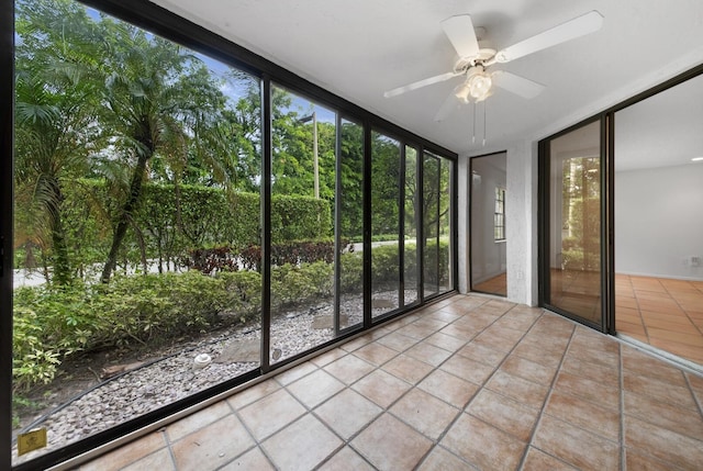 unfurnished sunroom with ceiling fan and a wealth of natural light