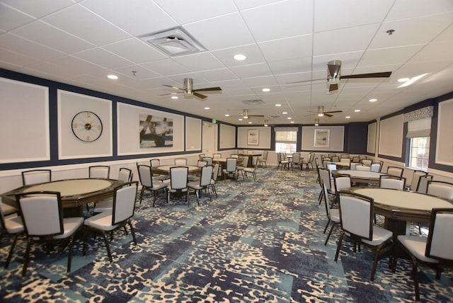 carpeted dining area with ceiling fan and a wealth of natural light