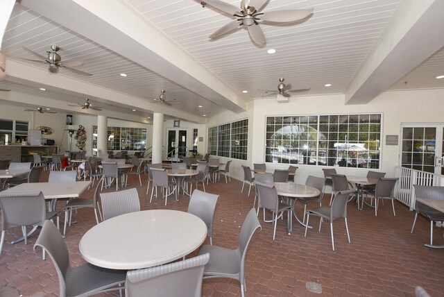 dining area with beamed ceiling and ceiling fan